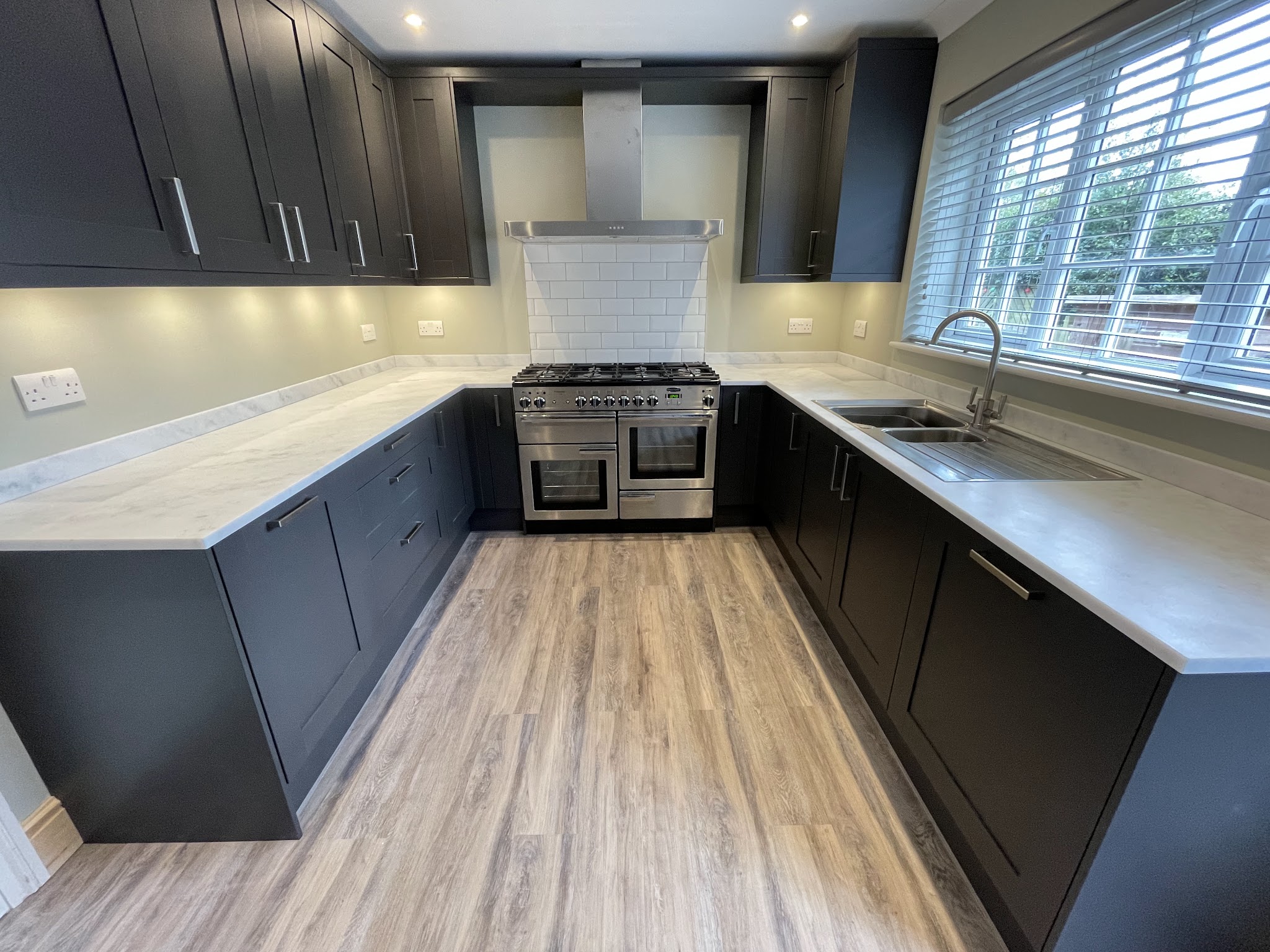 Dark shaker kitchen with a range cooker and pale worktops