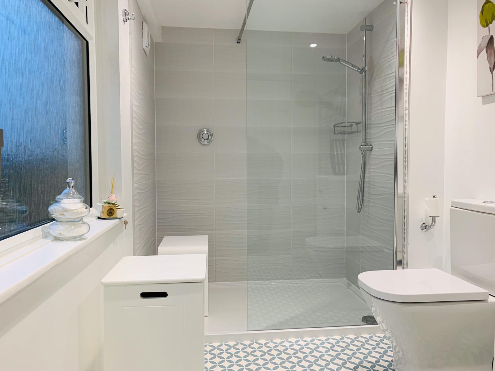 Bright shower room with a walk-in shower and patterned floor