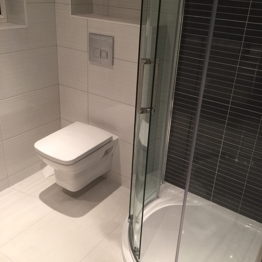 Wall-hung toilet and a quadrant shower enclosure