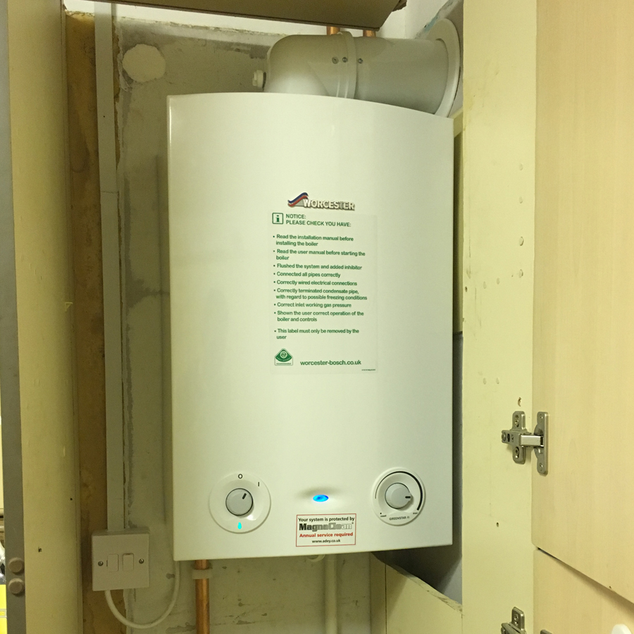 A heat-only boiler fitted inside a kitchen cupboard