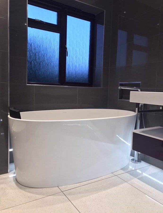 Freestanding bath in a dark bathroom